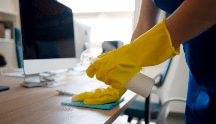 Office janitor cleaning a modern workspace with eco-friendly supplies—budget-friendly commercial cleaning in action.