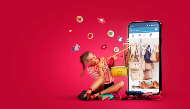 Woman shopping online using a device and credit card, representing social media-driven e-commerce sales.